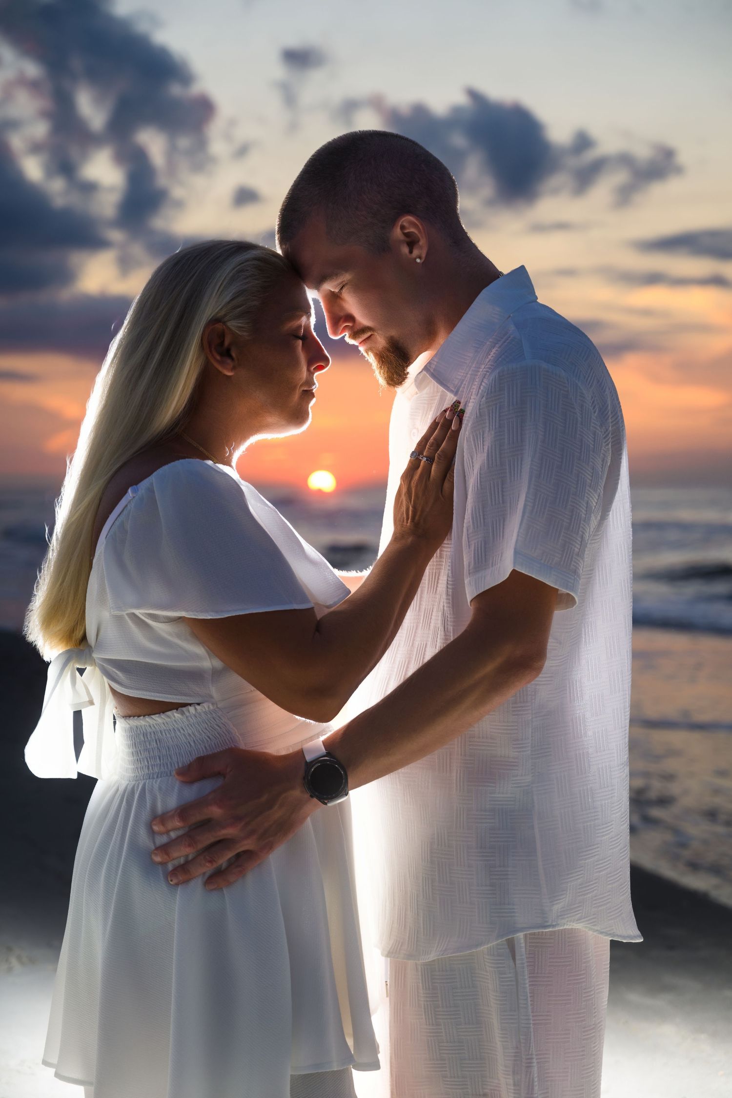 Couple sharing a quiet sunset portrait on the beach