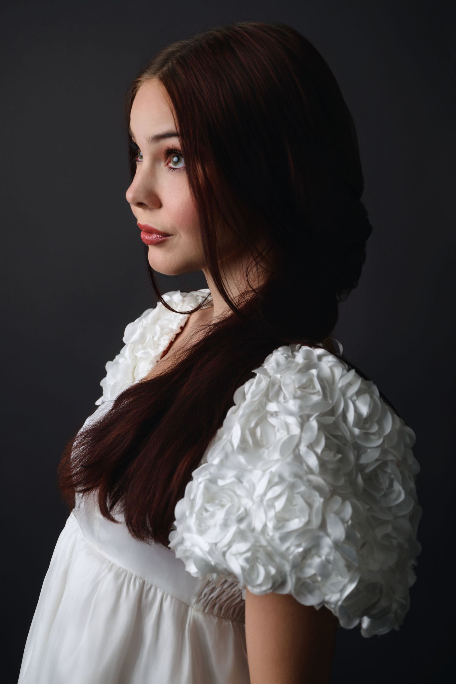 Studio portrait of a woman in a white floral dress